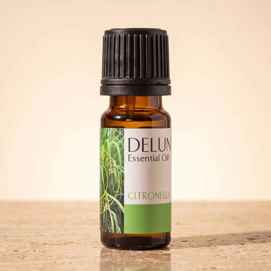 Delune Citronella Pure Essential Oil, 10ml amber glass bottle on warm travertine stone